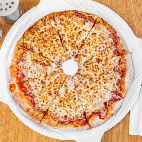 A whole cheese pizza, cut into eight slices, on a white paper-lined tray.